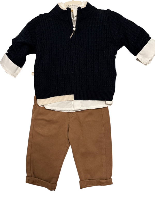 Children's outfit with navy sweater, white shirt, and brown pants on a white background